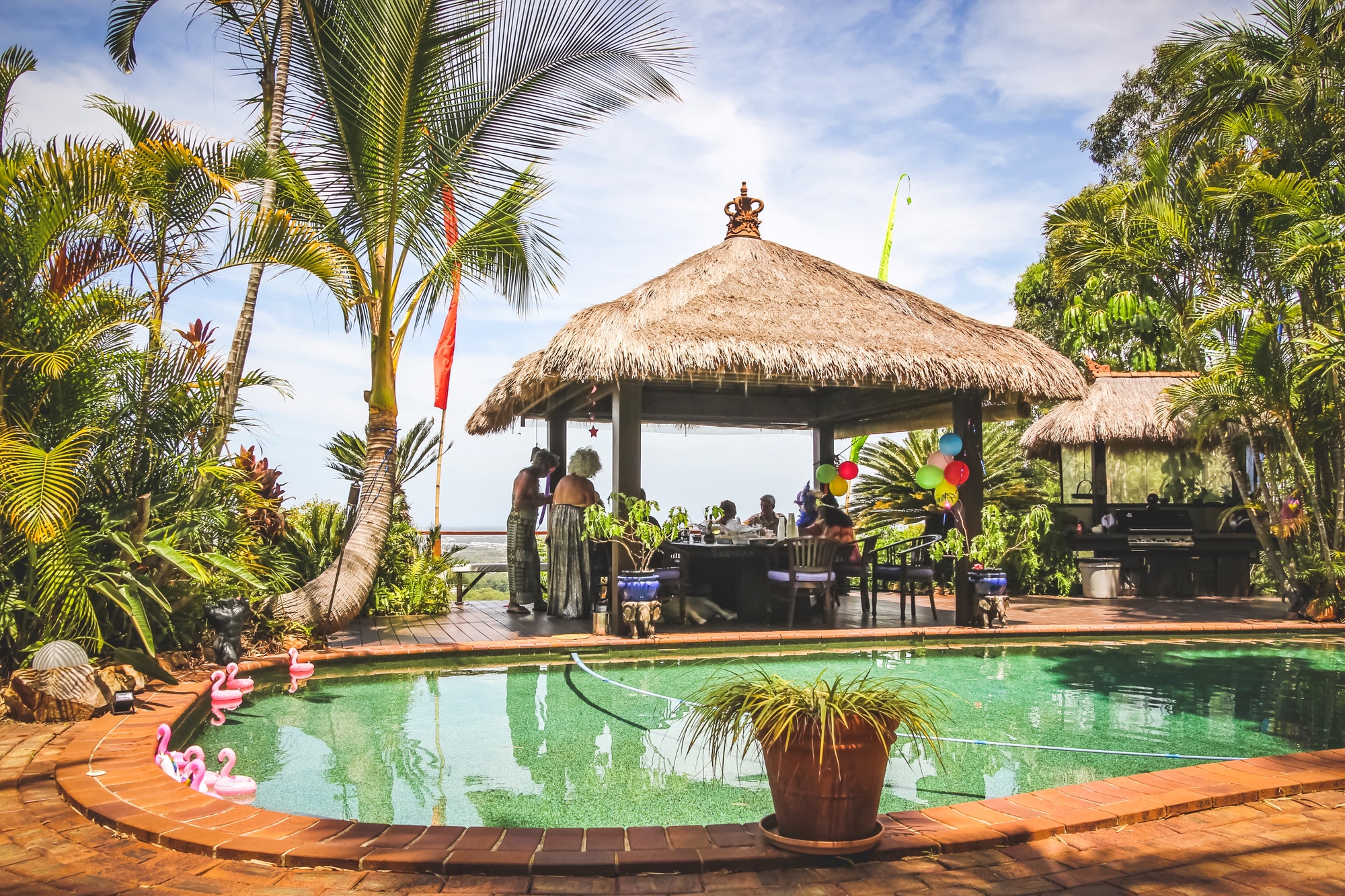 thatched-roof-gazebo-next-to-the-pool-a-great-place-for-backyard-parties.jpg